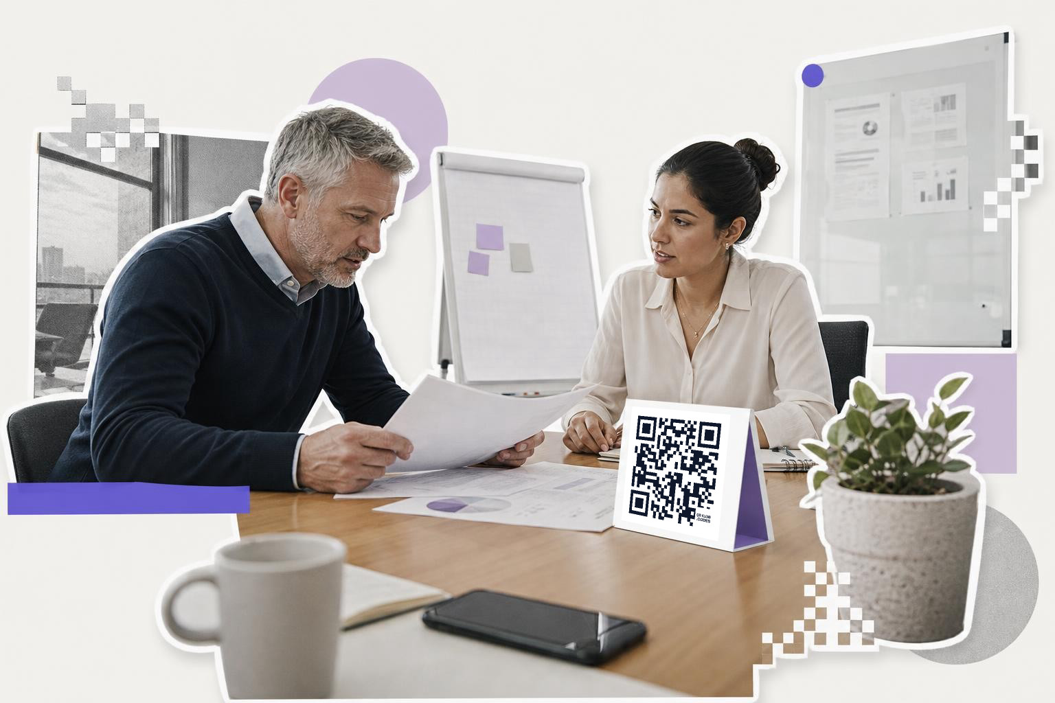 Two people discussing documents at a table with a QR code card and a potted plant.
