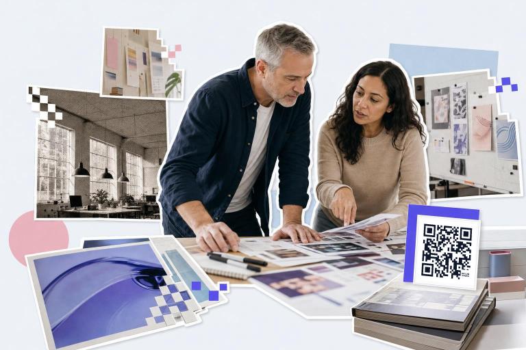 Two people reviewing design layouts on a table with a google analytics QR code tracking card nearby.